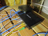 EdgeRouter 6p connected to ethernet and fibre, on shelf