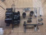 Caliper disassembled in ultrasonic cleaner basket