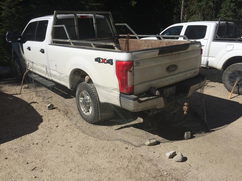 Truck with chicken wire around bottom of vehicle