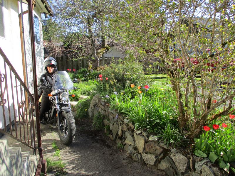 Meredith on her motorcycle Barbara out front of house